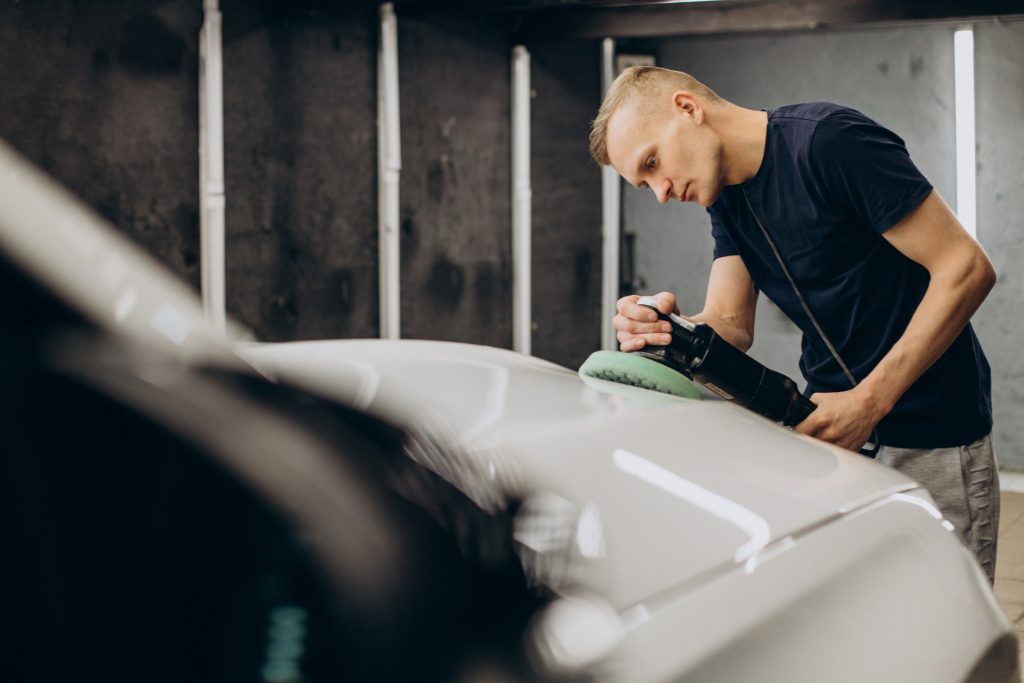 Man polishing car with orbital applicator